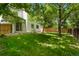 This spacious backyard features mature shade trees and plenty of grass, perfect for entertaining at 202 Hoover Ave, Louisville, CO 80027