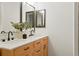 Bathroom featuring double sink vanity with sleek black fixtures, offering a blend of modern style at 202 Hoover Ave, Louisville, CO 80027