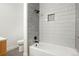 Modern bathroom with white subway tile in the shower, a niche for storage, and sleek fixtures at 202 Hoover Ave, Louisville, CO 80027