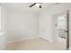 Neutral bedroom featuring a ceiling fan, closet, carpet floors and an open door at 202 Hoover Ave, Louisville, CO 80027