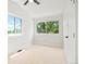 Bright bedroom offering neutral walls, carpet floors, a ceiling fan, and large windows at 202 Hoover Ave, Louisville, CO 80027