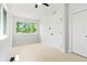 Fresh bedroom featuring neutral walls, carpet floors, a ceiling fan, and great windows at 202 Hoover Ave, Louisville, CO 80027