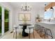 Bright dining area featuring modern lighting, an open layout, and easy access to the kitchen at 202 Hoover Ave, Louisville, CO 80027