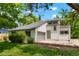 Attractive front yard with mature trees and landscaping, complements this renovated two story home at 202 Hoover Ave, Louisville, CO 80027