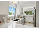 Bright, modern kitchen with white cabinets, subway tile backsplash, and stainless steel appliances at 202 Hoover Ave, Louisville, CO 80027