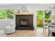 Cozy living room with fireplace and a view of the outdoor greenery through the sliding glass door at 202 Hoover Ave, Louisville, CO 80027