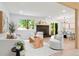 Bright living room featuring a modern fireplace, light wood floors, and ample natural light at 202 Hoover Ave, Louisville, CO 80027