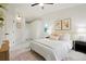 Bright primary bedroom featuring fresh white walls, a ceiling fan, and a neutral toned rug at 202 Hoover Ave, Louisville, CO 80027
