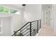 Modern staircase with black railing leading to an upper level, showcasing contemporary design at 202 Hoover Ave, Louisville, CO 80027