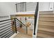 Modern staircase leading to a living area with stylish furnishings and a bright, open atmosphere at 202 Hoover Ave, Louisville, CO 80027