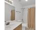 Cozy bathroom features a shower with a shower curtain and a vanity sink at 11115 E Alameda Ave # 203, Aurora, CO 80012