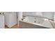 Bathroom features a white tub and a washing machine at 11115 E Alameda Ave # 203, Aurora, CO 80012