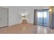 Bedroom features sliding glass door, wood floors, and lots of light at 11115 E Alameda Ave # 203, Aurora, CO 80012