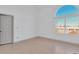 Bright bedroom with light hardwood flooring, fresh white walls, and a large arched window at 11115 E Alameda Ave # 203, Aurora, CO 80012