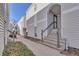 Inviting condo exterior with gray siding, concrete stairs, and an arched entryway at 11115 E Alameda Ave # 203, Aurora, CO 80012