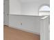 Bright hallway with light hardwood flooring and fresh white walls and arched window at 11115 E Alameda Ave # 203, Aurora, CO 80012