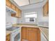 The kitchen features wood cabinets, white appliances, and lots of counter space at 11115 E Alameda Ave # 203, Aurora, CO 80012