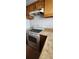 Kitchen area featuring a white range oven, light cabinets and laminate countertops at 11115 E Alameda Ave # 203, Aurora, CO 80012