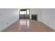Bright living room features fireplace, sliding glass door and wood flooring at 11115 E Alameda Ave # 203, Aurora, CO 80012