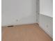 Bright room features light hardwood flooring and fresh white walls and a door at 11115 E Alameda Ave # 203, Aurora, CO 80012