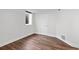 Basement bedroom with window, white walls and wood-look flooring at 5140 W 9Th Ave, Denver, CO 80204