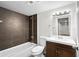 Bathroom features an updated vanity, and stylish dark tile in the shower at 5140 W 9Th Ave, Denver, CO 80204