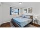 Comfortable bedroom with a stylish bed frame, soft blue bedding, and natural light from the window at 5140 W 9Th Ave, Denver, CO 80204