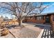 Beautiful brick home with a well-kept lawn, a sturdy fence, and a vibrant, mature tree at 5140 W 9Th Ave, Denver, CO 80204