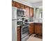 Functional kitchen with wooden cabinets, stainless steel appliances, and ample counter space at 5140 W 9Th Ave, Denver, CO 80204