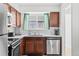 Clean kitchen featuring wooden cabinets, stainless steel appliances, and white countertops at 5140 W 9Th Ave, Denver, CO 80204