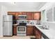 Well-lit kitchen with wooden cabinets, stainless steel appliances, and white subway tile backsplash at 5140 W 9Th Ave, Denver, CO 80204