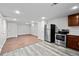 Well-lit kitchen with stainless steel appliances and newly installed wood-look vinyl flooring at 5140 W 9Th Ave, Denver, CO 80204