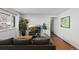 Cozy living room featuring hardwood floors, a comfortable gray sofa, and a large window at 5140 W 9Th Ave, Denver, CO 80204