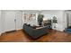 Inviting living room featuring hardwood floors, a gray sofa, and a large window for natural light at 5140 W 9Th Ave, Denver, CO 80204