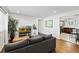 Cozy living room with hardwood floors, a comfortable gray sofa, and an archway to the kitchen at 5140 W 9Th Ave, Denver, CO 80204