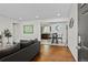 Bright living room showcasing hardwood floors, recessed lighting, and seamless flow to the dining area and kitchen at 5140 W 9Th Ave, Denver, CO 80204