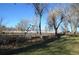 A sprawling backyard with a white fence, offering ample space for outdoor activities at 7250 County Road 5, Erie, CO 80516