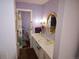 Well-lit bathroom featuring a shower, toilet and sink, and a gold-framed mirror at 7250 County Road 5, Erie, CO 80516