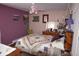 Cozy bedroom with purple walls and a patterned ceiling fan at 7250 County Road 5, Erie, CO 80516