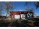 An oversized garage with multiple bays providing ample space for vehicles and storage, under a sunny, blue sky at 7250 County Road 5, Erie, CO 80516