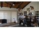 A functional office space with wood beam and rustic wooden ceiling, shelving, and natural light at 7250 County Road 5, Erie, CO 80516