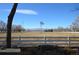 Scenic property view features an expansive field, a white fence, and a vintage windmill against a clear, blue sky at 7250 County Road 5, Erie, CO 80516