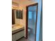 Bright bathroom with a single sink vanity and a large framed mirror at 4812 S Bahama Way, Aurora, CO 80015