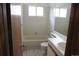 Bathroom with a bathtub, single sink vanity, toilet and a large mirror at 4812 S Bahama Way, Aurora, CO 80015