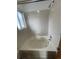 Bathroom featuring a tiled shower and a clear glass window at 4812 S Bahama Way, Aurora, CO 80015