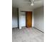 Bedroom features neutral carpet, a ceiling fan, and closet with wood sliding doors at 4812 S Bahama Way, Aurora, CO 80015