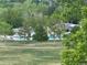 View from back of property overlooking the community pool, green spaces, and mature trees at 4812 S Bahama Way, Aurora, CO 80015