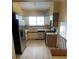 Well-equipped kitchen featuring stainless steel appliances, a window, and neutral-toned cabinetry at 4812 S Bahama Way, Aurora, CO 80015