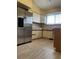 Functional kitchen with stainless steel refrigerator, wood cabinets, light countertops and vinyl flooring at 4812 S Bahama Way, Aurora, CO 80015