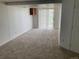 Cozy living room with plush neutral carpet, white walls and access to the outdoors at 4812 S Bahama Way, Aurora, CO 80015